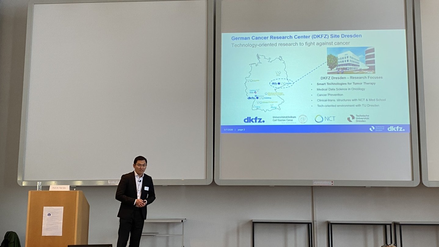 Tian Qiu presenting a slide about DKFZ Dresden research activities during a scientific conference.